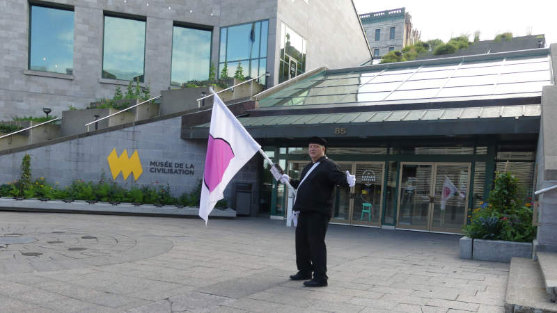 Je marche avec mon drapeau de la fierté ronde devant le musée de la civilisation